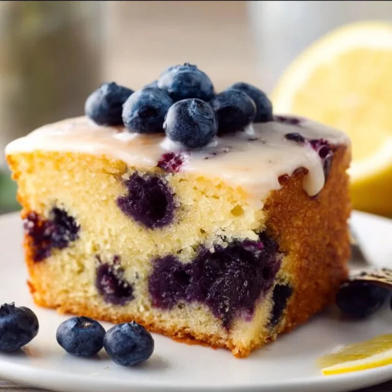 Lemon Blueberry Cake topped with fresh blueberries and lemon zest