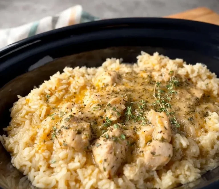 Crock Pot chicken and rice dish garnished with herbs in a bowl